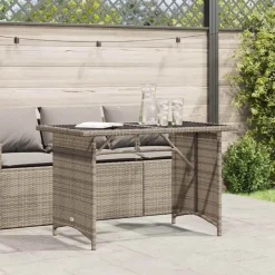 vidaXL Mesa de jardín superficie de vidrio ratán PE 110x68x70 cm Gris Hot